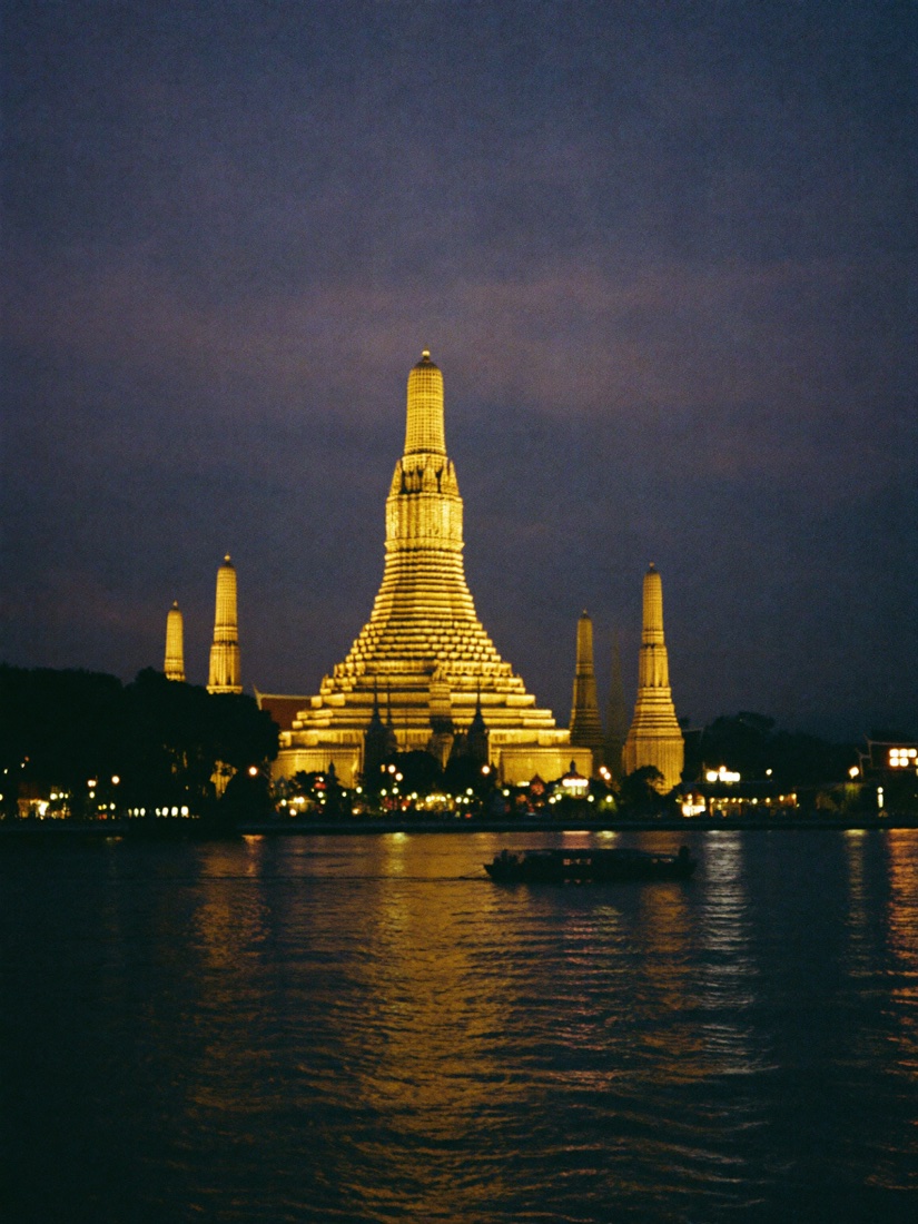 Wat Arun lit at night across the Chao Phraya river