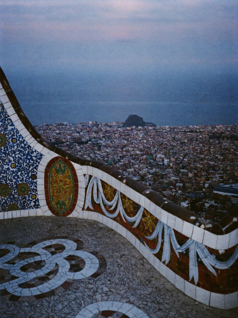 The mosaic terrace of Park Guell above Barcelona at dawn