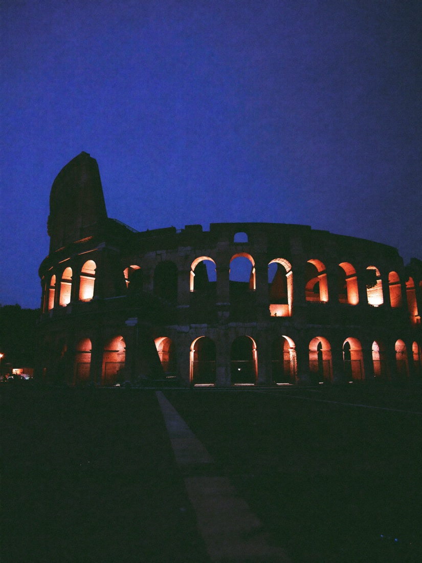 The Colosseum arches lit from within at night