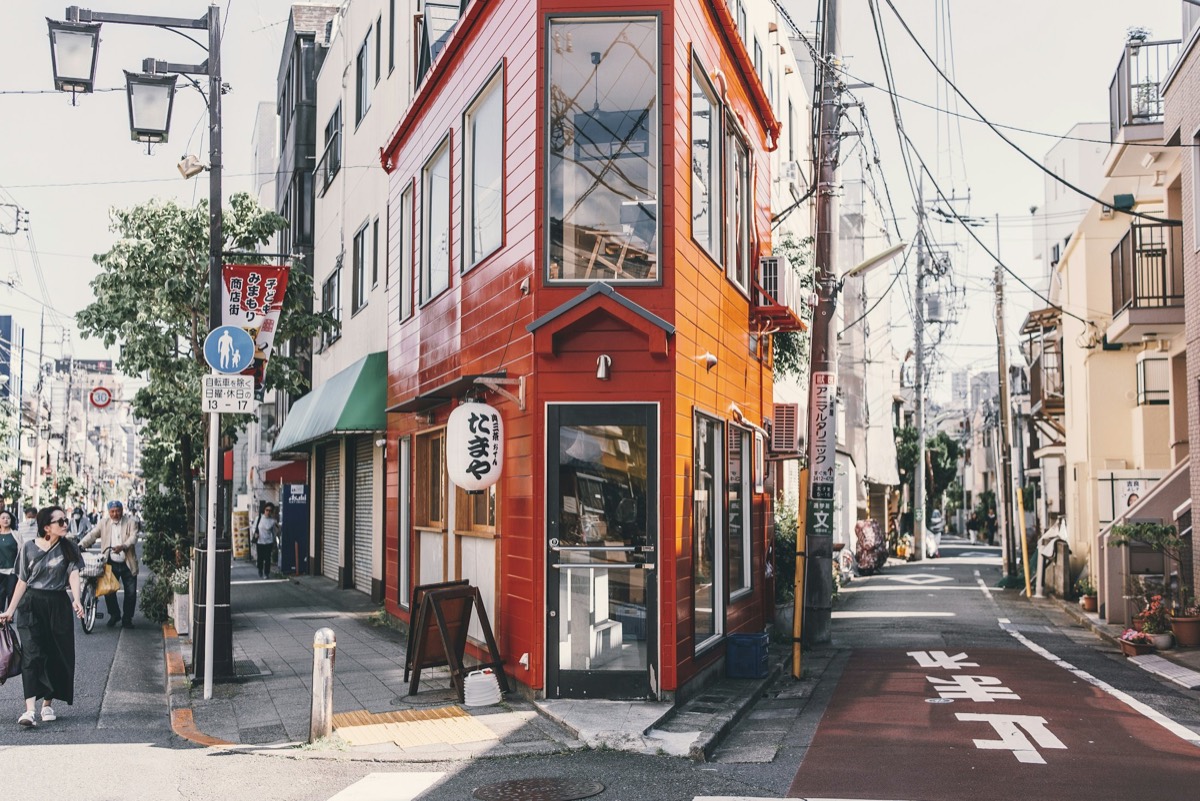 A red corner shop on a Tokyo side street in daylight